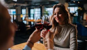 Guests at Blackstone Grille restaurant tavern and bar in Chattanooga, Tennessee clink together red wine glasses