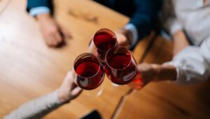 Three red wine glasses clinking together at Blackstone Grille restaurant tavern and bar in Chattanooga, Tennessee